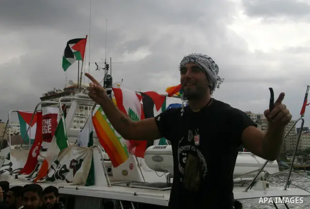 A crowd gathers around the "dignity" boat that departed from Cyprus yesterday afternoon to protest against the Israeli sanctions imposed on Gaza Strip since June 2007, at the port in Gaza City. The boat carrying 27 pro-P...