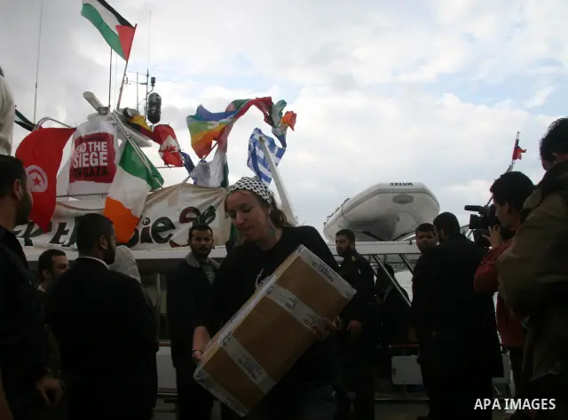 A crowd gathers around the "dignity" boat that departed from Cyprus yesterday afternoon to protest against the Israeli sanctions imposed on Gaza Strip since June 2007, at the port in Gaza City. The boat carrying 27 pro-P...
