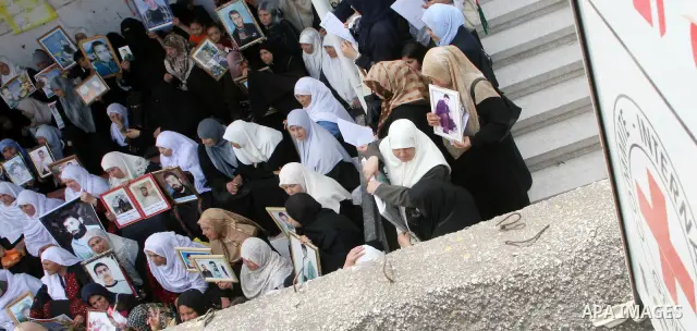 Palestinian women hold pictures of relatives they say are being held in Israeli jails during a protest demanding the release of prisoners in Gaza City. After a nearly 10-month standoff in efforts to secure the release of...