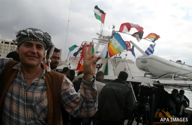 A crowd gathers around the "dignity" boat that departed from Cyprus yesterday afternoon to protest against the Israeli sanctions imposed on Gaza Strip since June 2007, at the port in Gaza City. The boat carrying 27 pro-P...