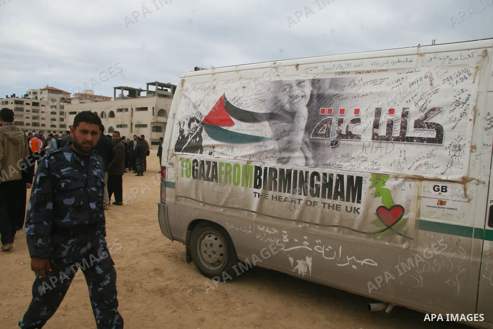 Palestinian Hamas security stand next to a car of a British aid convoy for Gaza, in Gaza City, 10 March 2009. British MP George Galloway arrived in Gaza at the head of an aid convoy to protest what he called Israel's 'ge...