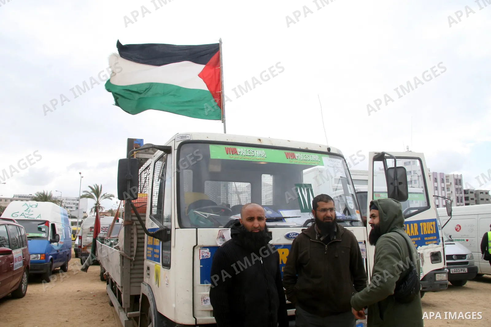 Members of a British aid convoy stand near their car in Gaza City, 10 March 2009. British MP George Galloway arrived in Gaza at the head of an aid convoy to protest what he called Israel's 'genocidal aggression' against...