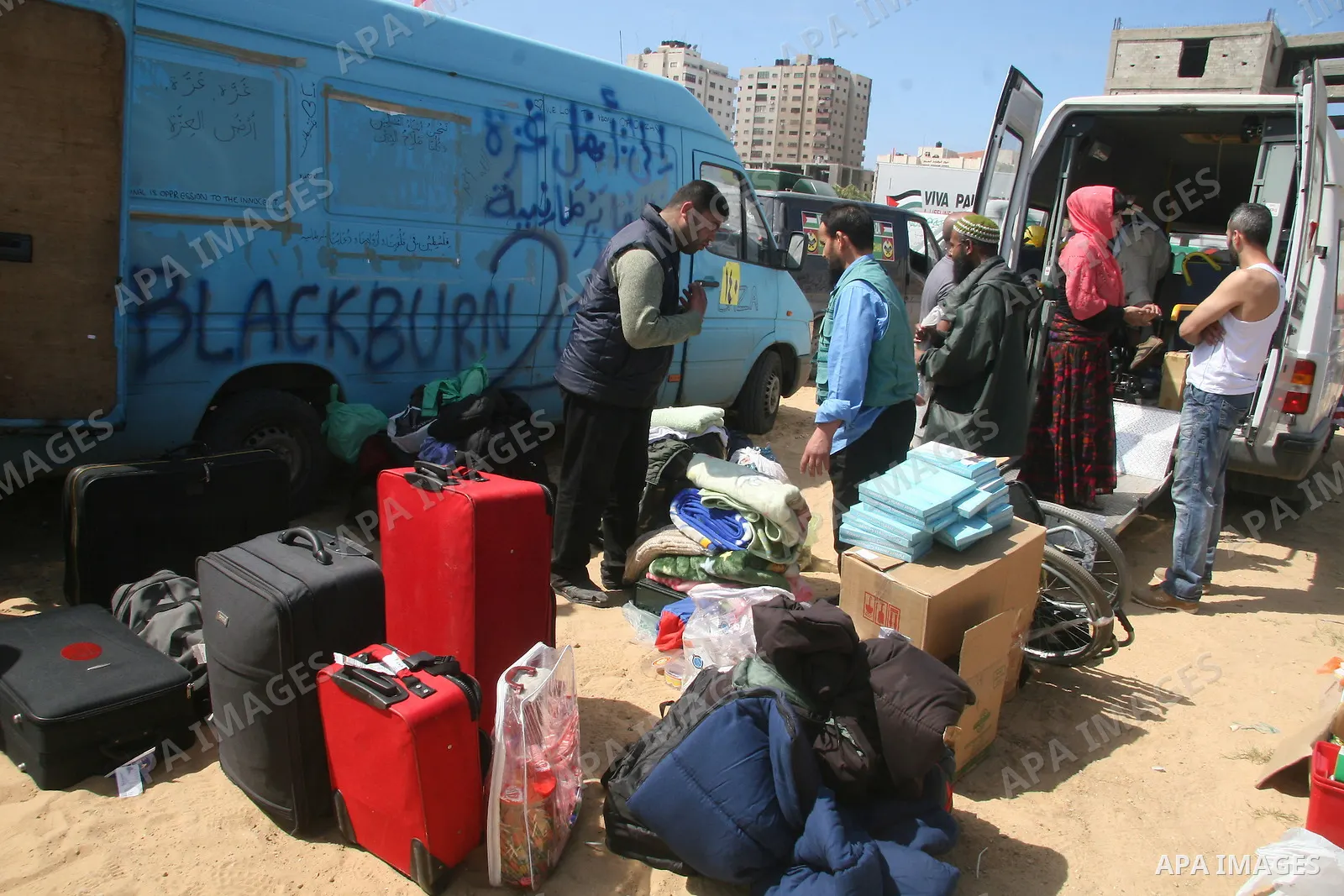 Members of a British aid convoy stand near their car in Gaza City, 10 March 2009. British MP George Galloway arrived in Gaza at the head of an aid convoy to protest what he called Israel's 'genocidal aggression' against...