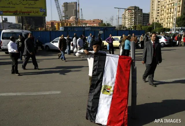 Egyptian youth sells national flags at the Tahrir square in Cairo, Egypt, Thuresday, March 3, 2011. hundreds of protesters are camping at the Tahrir square in an ongoing campaign demanding the resignation of the current...