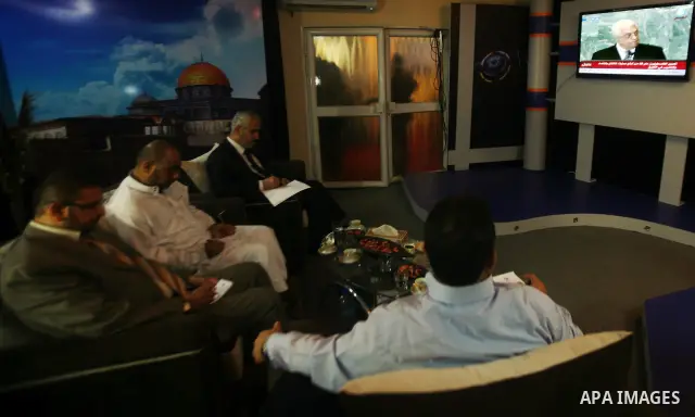 Palestinian Hamas spokesmen watch a television broadcast of Palestinian President Mahmoud Abbas speaking at the United Nations in New York, in Gaza City, on 23 September 2011. Palestinian President Mahmoud Abbas on the s...