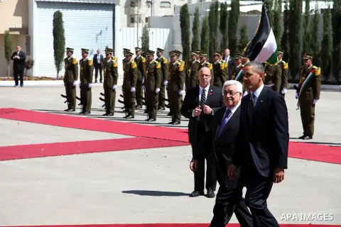 U.S. President Barack Obama gestures while walking next to Palestinian President Mahmoud Abbas before reviewing troops during an arrival ceremony at the Muqata Presidential Compound in the West Bank City of Ramallah Marc...