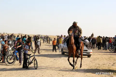 Palestinians jockey take part in a camel race in southern Gaza strip town of Khan Younis, on Apr. 26, 2013. Photo by Mosad Al Mahmom