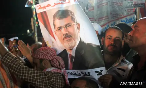 Supporters of Egypt's ousted President Mohammed Morsi chant slogans during a protest outside Rabaa al-Adawiya mosque, where they have installed a camp and hold daily rallies at Nasr City, in Cairo, Egypt, Wednesday, July...
