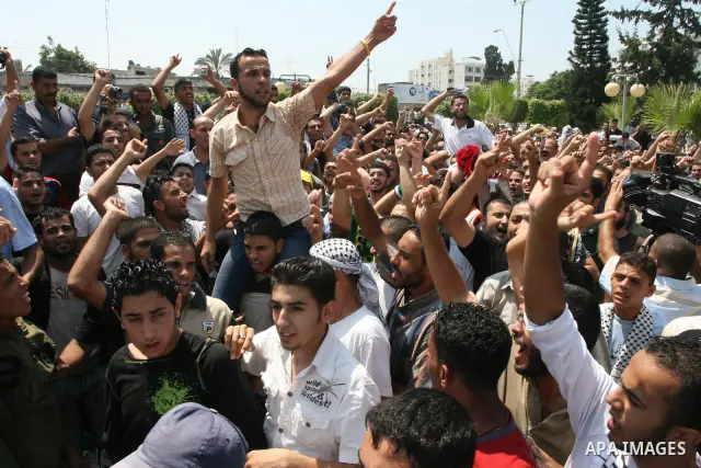 Fatah movement supporters shout as they take part in a rally following Friday noon prayers in Gaza City. Security forces from the ruling Hamas detained four journalists, including an AFP photographer as it broke up a mas...