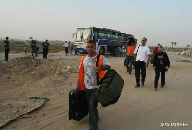 Palestinians leave Gaza through the Erez crossing in the northern Gaza strip. Hundreds of Palestinians left through the northern Erez crossing on their way to Egypt after Israeli authorities granted permission to those h...