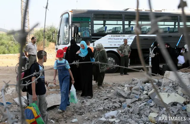 Palestinians leave Gaza through the Erez crossing in the northern Gaza strip. Hundreds of Palestinians left through the northern Erez crossing on their way to Egypt after Israeli authorities granted permission to those h...