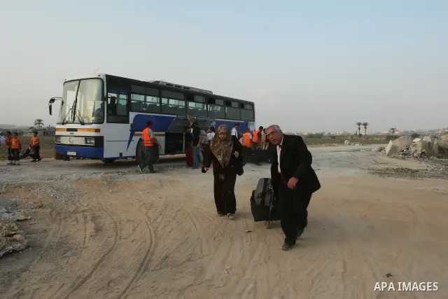Palestinians leave Gaza through the Erez crossing in the northern Gaza strip. Hundreds of Palestinians left through the northern Erez crossing on their way to Egypt after Israeli authorities granted permission to those h...