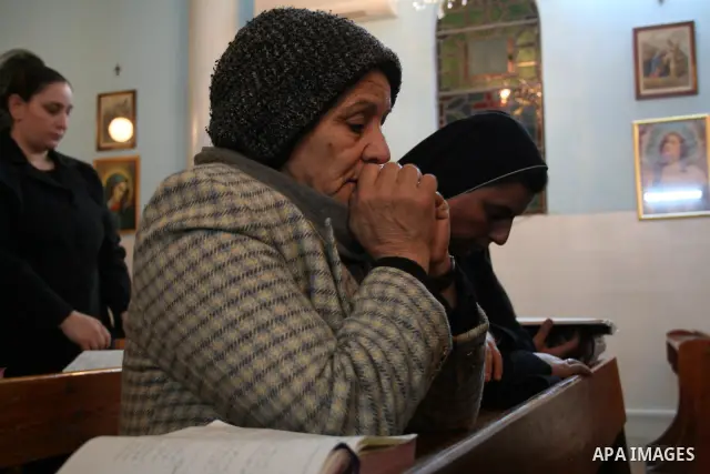 Christian worshippers pray in Deir al-Laten Church ahead of Christmas in Gaza.