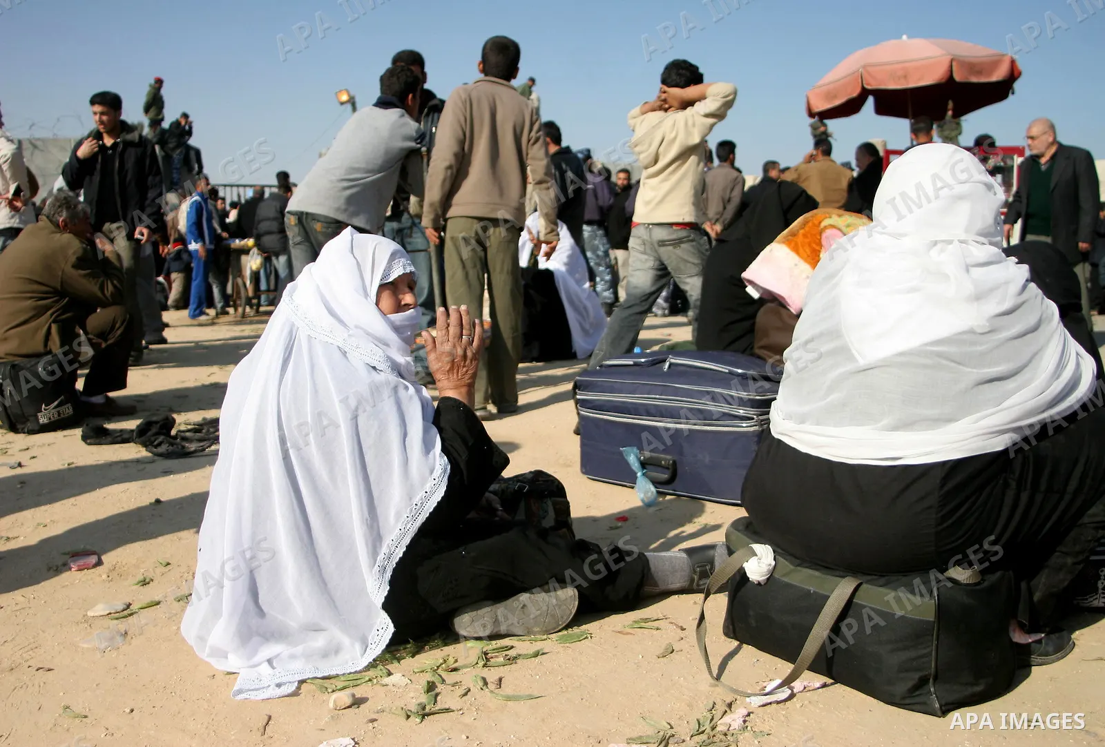 Palestinians wait to cross the Rafah border crossing from the Gaza Strip into Egypt. Citing security threats, Israel allows the Rafah crossing, Gaza's only gateway to the outside world, to operate only sporadically, lead...