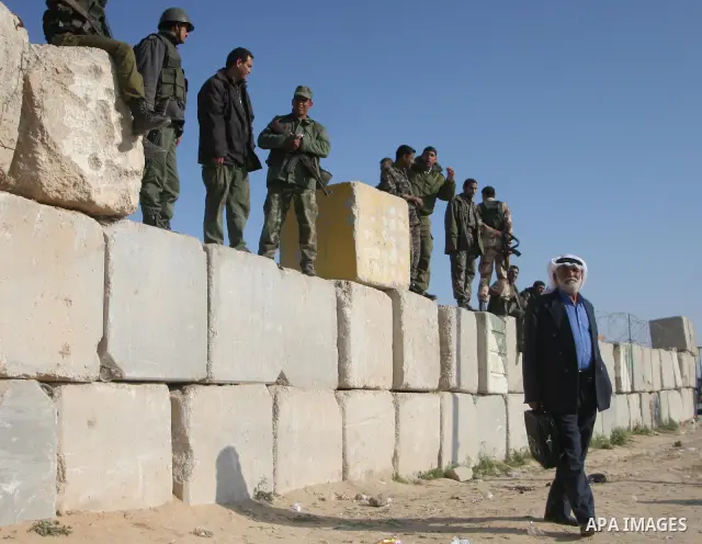 Palestinians wait to cross the Rafah border crossing from the Gaza Strip into Egypt. Citing security threats, Israel allows the Rafah crossing, Gaza's only gateway to the outside world, to operate only sporadically, lead...
