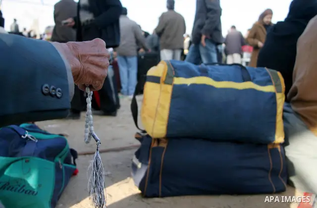 Palestinians wait to cross the Rafah border crossing from the Gaza Strip into Egypt. Citing security threats, Israel allows the Rafah crossing, Gaza's only gateway to the outside world, to operate only sporadically, lead...