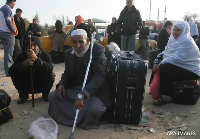 Palestinians wait to cross the Rafah border crossing from the Gaza Strip into Egypt. Citing security threats, Israel allows the Rafah crossing, Gaza's only gateway to the outside world, to operate only sporadically, lead...