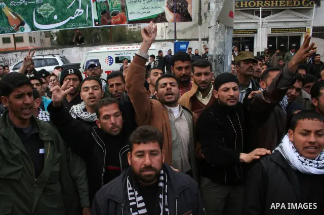 Palestinians attend a protest to demand jobs in the Palestinian Authority, in Gaza. Palestinian leaders struck discordant notes on how to deal with Israel on Saturday as parliament met to usher in a unity government inte...
