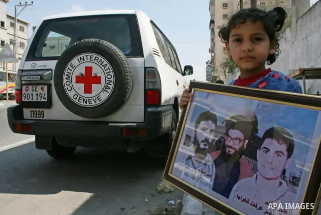 Palestinian women hold pictures of relatives they say are being held in Israeli jails during a protest demanding the release of prisoners in Gaza City. After a nearly 10-month standoff in efforts to secure the release of...
