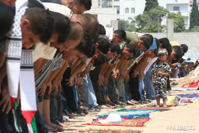 Palestinian Fatah party supporters take part in Friday noon prayers in Gaza City. More than 10,000 Palestinians have defied Hamas to pray outside in the biggest protest in the Gaza Strip since the radical Islamist moveme...