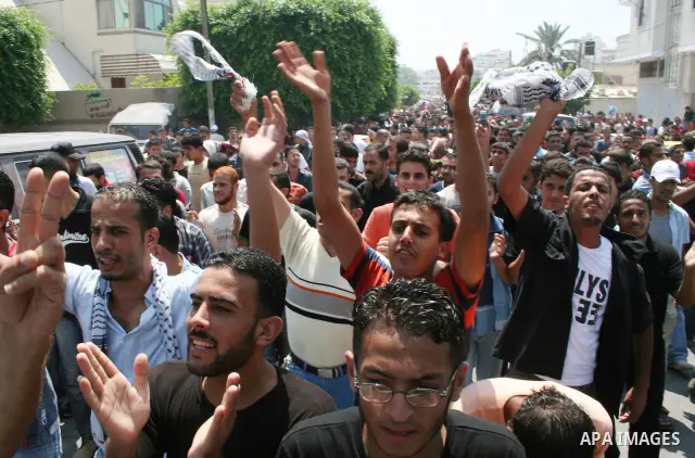 Palestinian Fatah party supporters shout as they take part in a rally following Friday noon prayers in Gaza City. More than 10,000 Palestinians have defied Hamas to pray outside in the biggest protest in the Gaza Strip s...