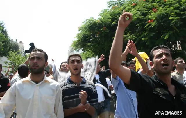 Palestinian Fatah party supporters shout as they take part in a rally following Friday noon prayers in Gaza City. More than 10,000 Palestinians have defied Hamas to pray outside in the biggest protest in the Gaza Strip s...
