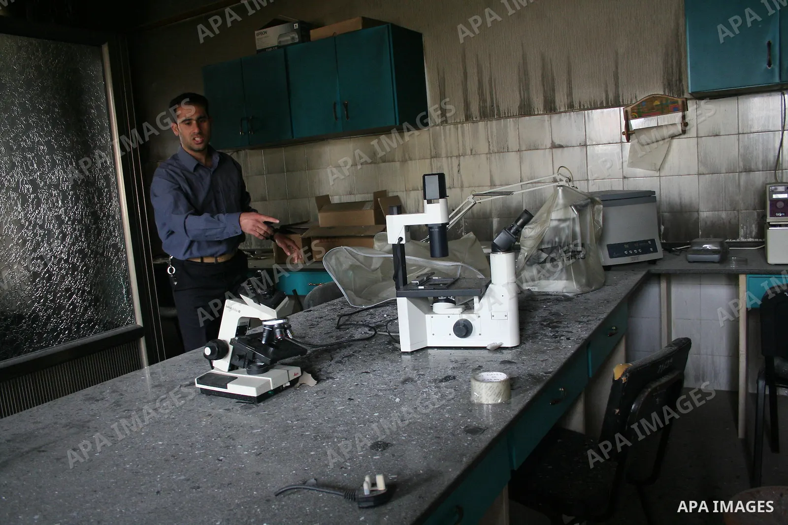 Palestinians inspect a burnt building inside the Islamic University after it was attacked in Gaza. Fighting between rival Palestinian factions escalated across Gaza on Friday, killing at least 17 people, as Hamas Islamis...