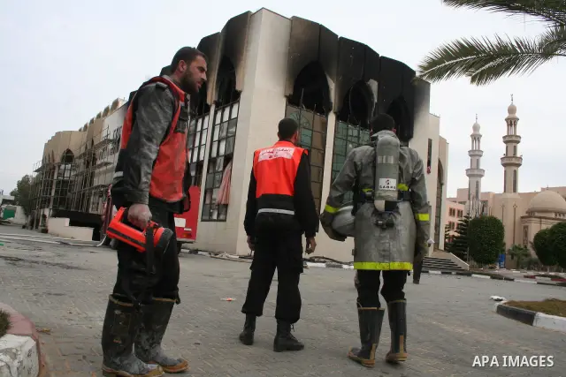 Palestinians inspect a burnt building inside the Islamic University after it was attacked in Gaza. Fighting between rival Palestinian factions escalated across Gaza on Friday, killing at least 17 people, as Hamas Islamis...