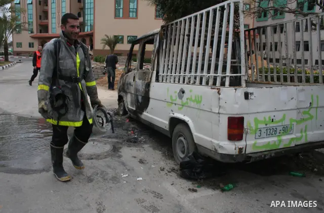 Palestinians inspect a burnt building inside the Islamic University after it was attacked in Gaza. Fighting between rival Palestinian factions escalated across Gaza on Friday, killing at least 17 people, as Hamas Islamis...