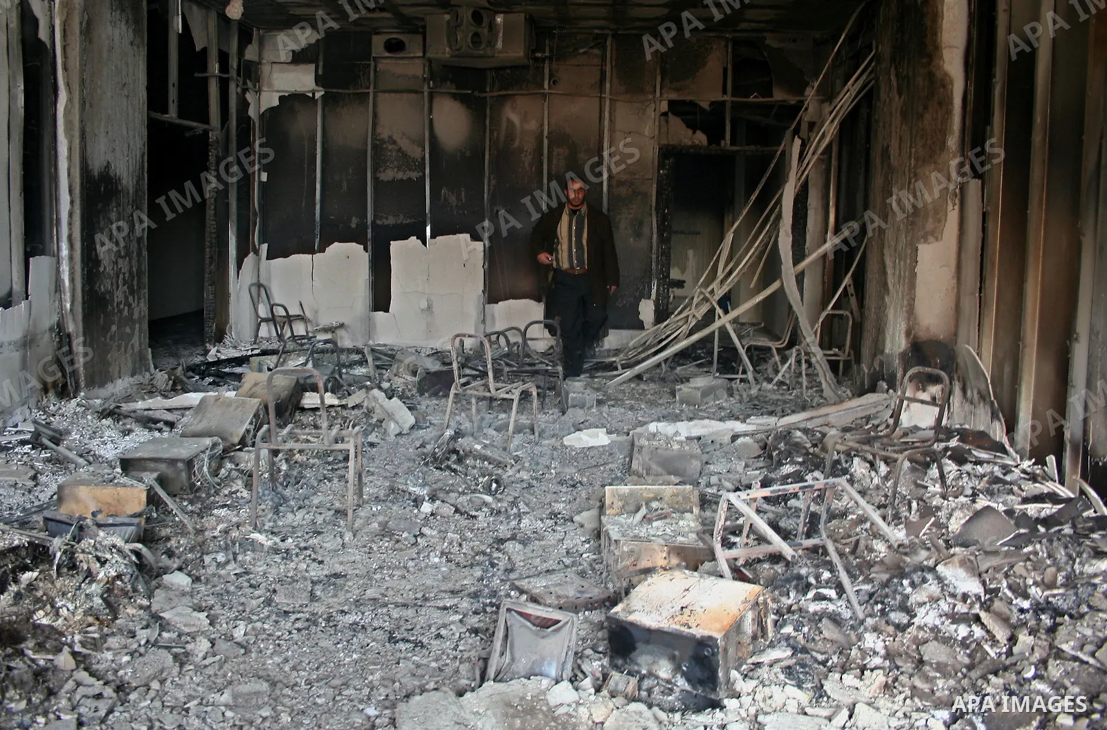 Palestinians inspect a burnt building inside the Islamic University after it was attacked in Gaza. Fighting between rival Palestinian factions escalated across Gaza on Friday, killing at least 17 people, as Hamas Islamis...
