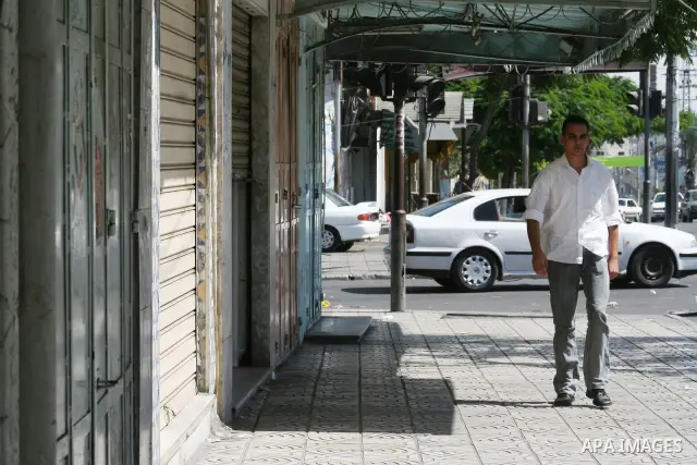 Palestinians walk passed closed shops during a general strike called by supporters of the Fatah Movement in the West Bank. Activists in the Fatah movement declared a general strike across the Gaza Strip and parts of the...
