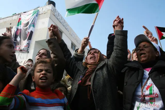 Palestinians shout slogans and hold Palestinian flags during a demonstration against the internal fighting between the Hamas and Fatah movements in Gaza City.