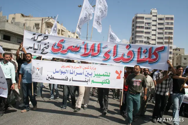 Supporters of Fateh al-Yasser take part in a protest outside the Red Cross office in Gaza City demanding the release of relatives being held in an Israeli jails. Israel said today it wants a US-sponsored peace conference...