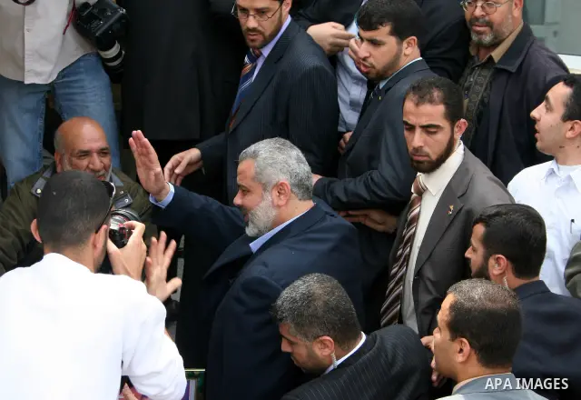 Palestinian Prime Minister Ismail Haniyeh waves to the relatives of prisoners during a protest calling for the release of Palestinian prisoners from Israeli jails, in Gaza.