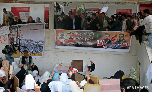 Palestinian Prime Minister Ismail Haniyeh waves to the relatives of prisoners during a protest calling for the release of Palestinian prisoners from Israeli jails,in front of the red cross headquarters in Gaza...