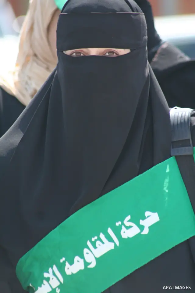 A Palestinian woman supporter of the Hamas movement stands during a demonstration in front of the legislative council in Gaza City. Palestinian women demanding to halt the palestinian authority forces's violences against...