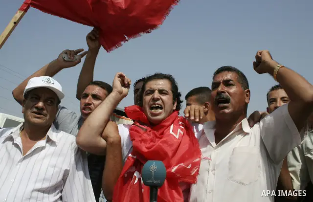 Palestinians released from Israeli jail shout after crossing into the Gaza Strip, following their release at the Erez crossing by Israeli border police. Israel sent 29 Palestinian prisoners back to the Gaza Strip on Tues...
