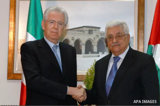 Palestinian President Mahmoud Abbas, meets with Italy's Prime Minister Mario Monti past an honour guard during a welcoming ceremony in the West Bank city of Ramallah April 8, 2012. Photo by Thaer Ganaim