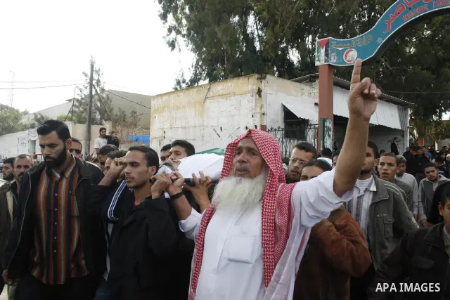 Palestinians carry the bodies of four Hamas militants during their funeral in Khan Younis refugee camp, southern Gaza Strip. The four Hamas militants were killed Wednesday as Israeli troops and Palestinian militants foug...