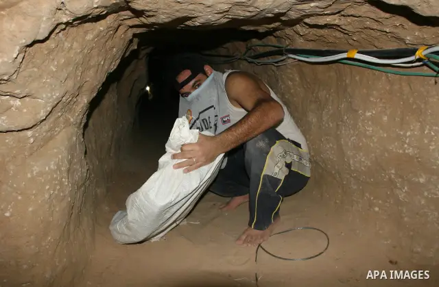 Palestinian smuggler brings goods into Gaza through underground tunnel beneath the border with Egypt in southern Gaza Strip town of Rafah