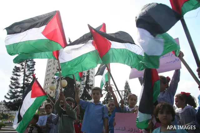 Palestinian children holding a Palestinian flags, participate a protest against the Israeli sanctions on Gaza in Gaza City. Israel has reduced shipments of fuel and other supplies into Gaza since Hamas took control of Ga...
