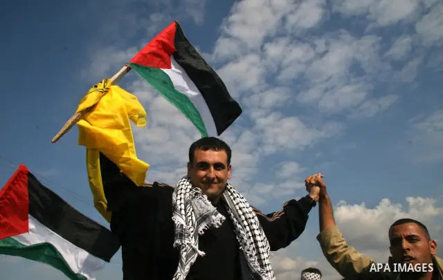 Palestinians released from an Israeli jail are hugged by their relatives after crossing into the Gaza Strip, following his release at the Erez crossing. Israel released 224 Palestinian prisoners Monday in a gesture to mo...