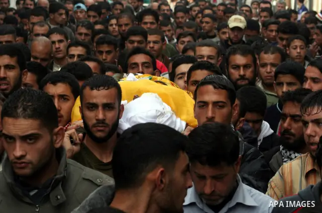 Palestinians carry the body of Ali Hijazi , 26, a member of the Al Aqsa Martyrs' Brigades, during his funerall in the town of Beit Lahiya in the northern Gaza Strip. An Israeli air strike killed Hijazi in the Gaza Strip...