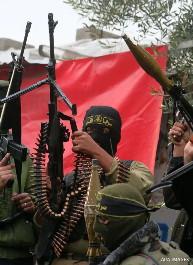 Masked Palestinian militants hold their weapons during an Islamic Jihad rally in Bureij, central Gaza Strip, Friday, Dec. 26, 2008. Israeli defense officials say politicians have approved a large-scale incursion into the...