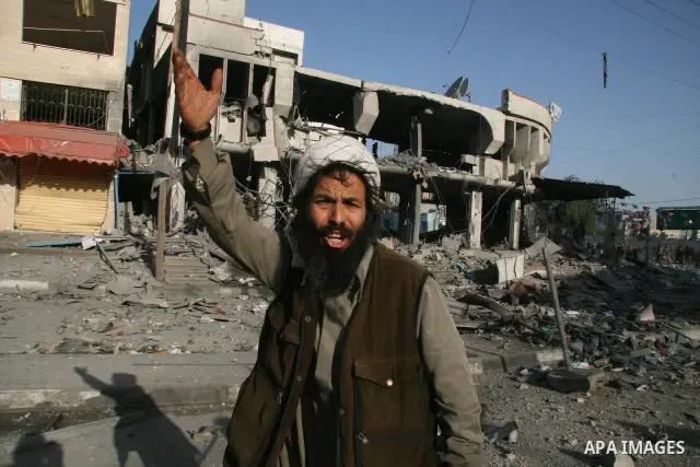 Palestinians look at destroyed buildings after an explosion from an Israeli missile strike in Gaza City. Israeli warplanes pounded the Hamas-ruled Gaza Strip for a third consecutive day on Monday and the Jewish state pre...