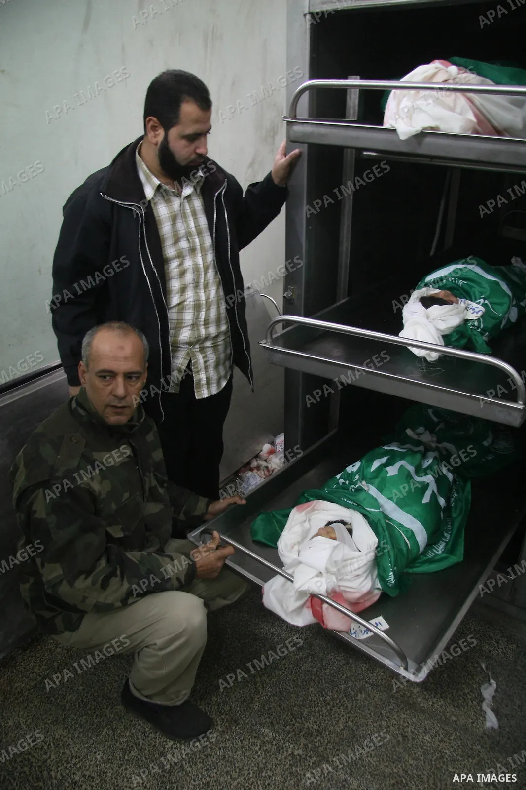 Palestinians mourns during the funeral of Dena Baloshathe and her four sisters in Jabalya refugee camp in the northern Gaza Strip December 29, 2008. Palestinian medics said five young sisters, one of them Dena Balosha, d...