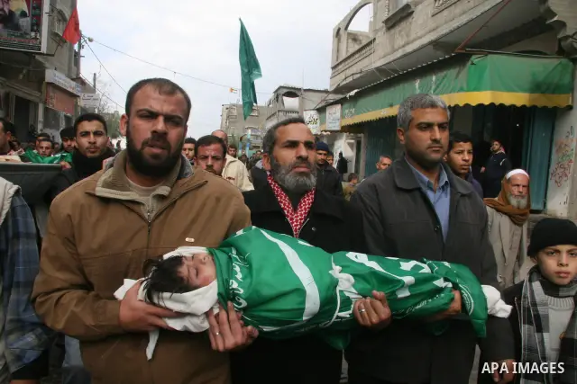 Palestinians mourns during the funeral of Dena Baloshathe and her four sisters in Jabalya refugee camp in the northern Gaza Strip December 29, 2008. Palestinian medics said five young sisters, one of them Dena Balosha, d...