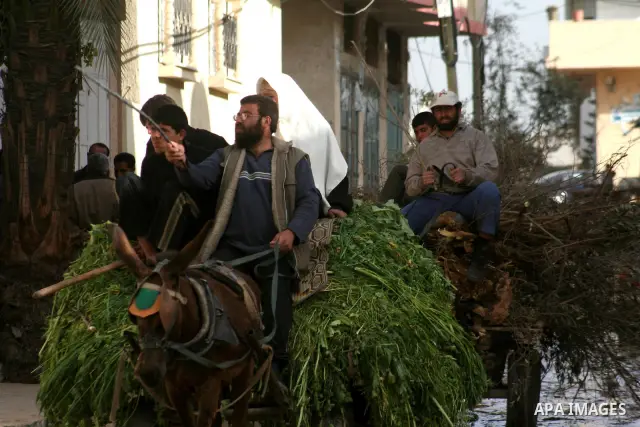 Palestinians leave a devastated area of eastern Jebaliya, northern Gaza strip in horse carts Wednesday, Jan. 29, 2009. President Barack Obama's new Mideast envoy sought Wednesday to boost a 10-day-old Gaza cease-fire tha...