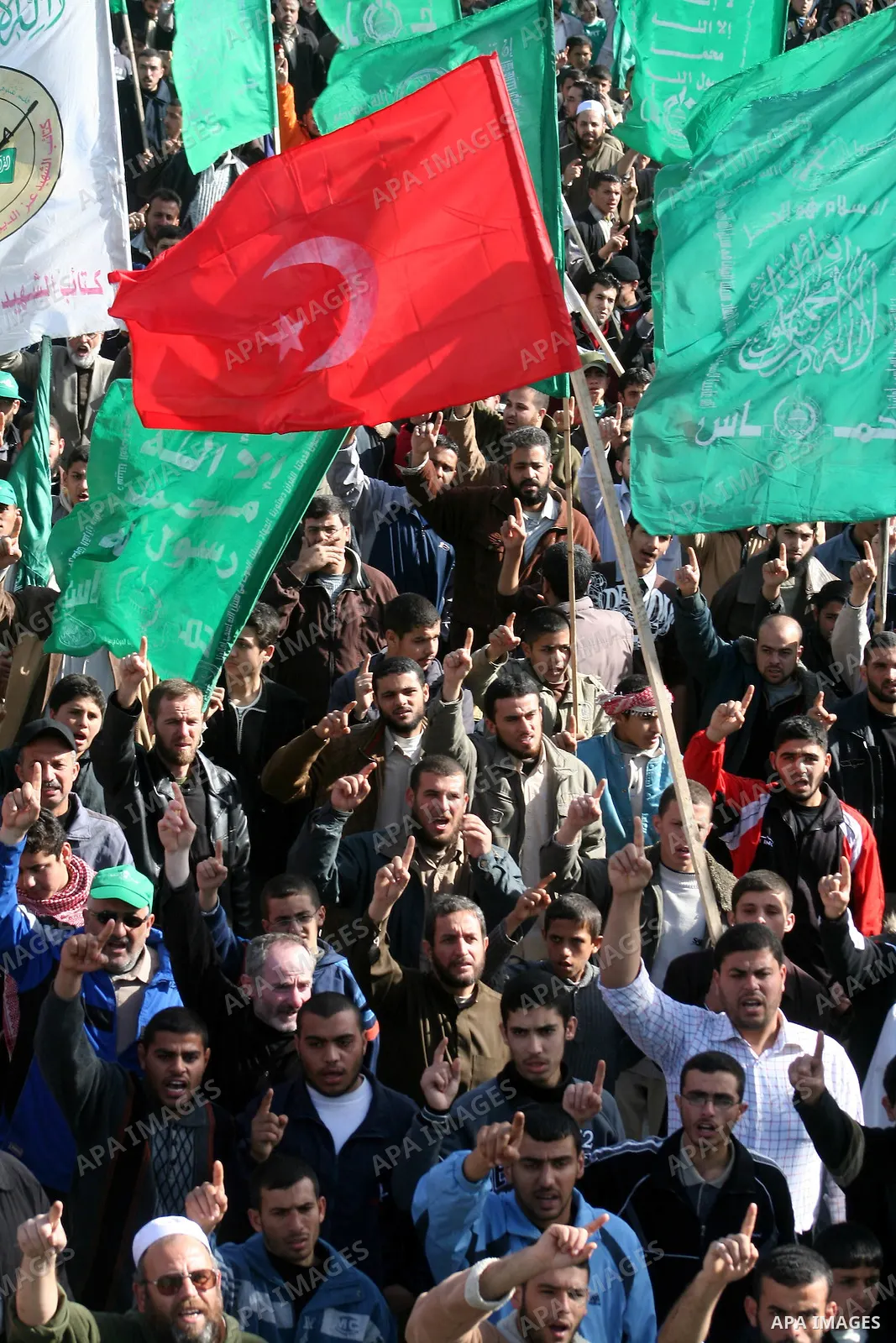 A Turkish flag is seen as Palestinians pray in front of the destroyed parliament building prior to attending a rally in support of Hamas in Gaza city, Friday Jan. 30, 2009. Turkish Prime Minister Tayyip Erdogan is winnin...