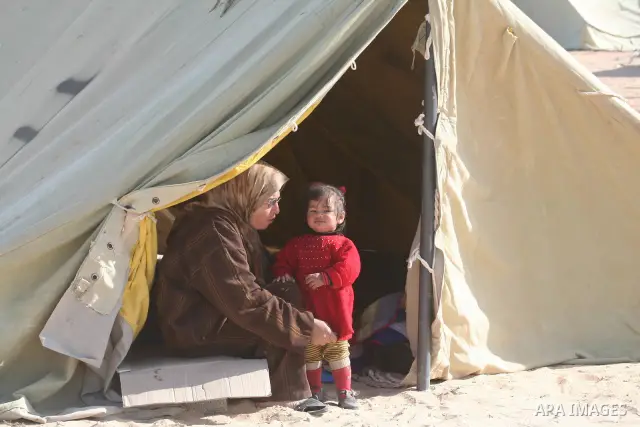 A Palestinian woman and her daughter sit at the entrance of a tent serving as temporary shelter after their house was destroyed during the 22-day Israeli offensive in Jabalia in the northern Gaza Strip on January 31, 200...